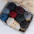 Assorted balls of Brushtale Possum yarn in a basket 
