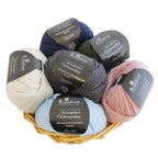 Basket of Broadway Super Chunky yarn in various colors on a white background