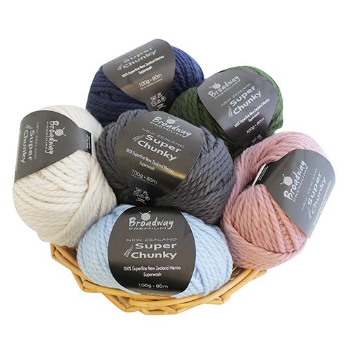 Basket of Broadway Super Chunky yarn in various colors on a white background