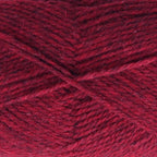 Close-up of dark red yarn with a tweedy texture