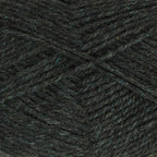 Close-up of dark forest green yarn with a tweedy texture