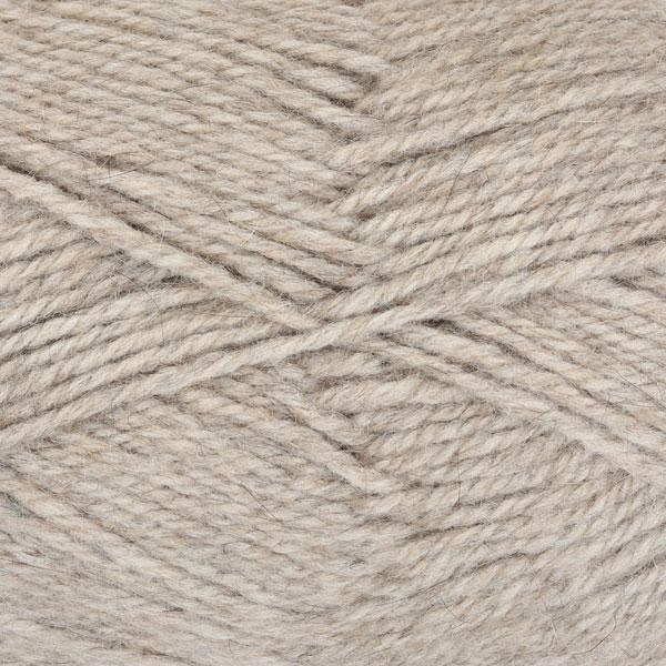 Close-up of natural undyed beige yarn with a tweedy texture