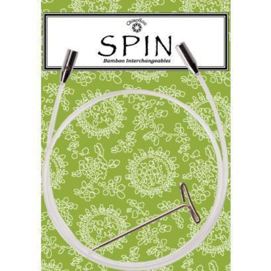 Knitting needle cable on a green patterned background, branded 'Spin'.