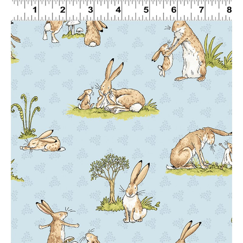 Children's Quilting fabric with a blue background featuring illustrations of rabbits and other animals.
