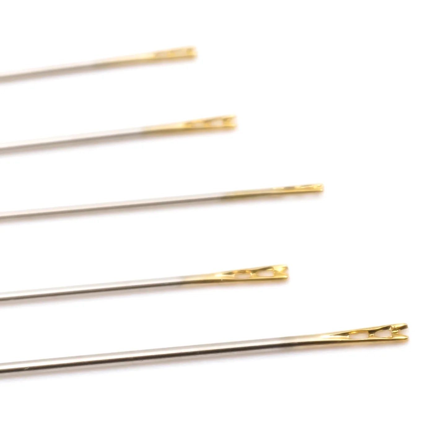 Close up of set of gold hair pins on a white background