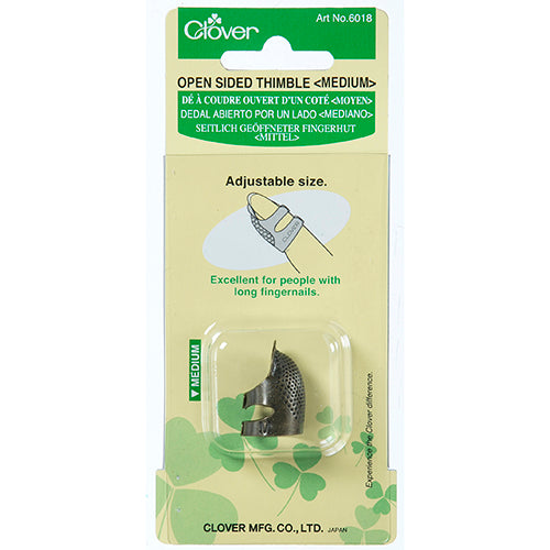 Clover open-sided thimble packaging with thimble inside on a white background