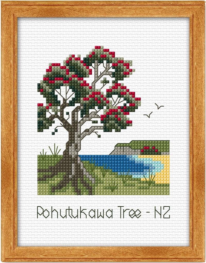 Cross-stitched design of a Pohutukawa tree with berries and a lake, framed in wood.
