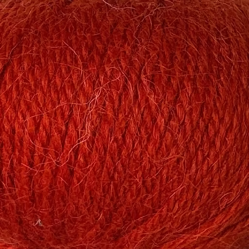 Close-up of reddish-orange yarn with alpaca and merino