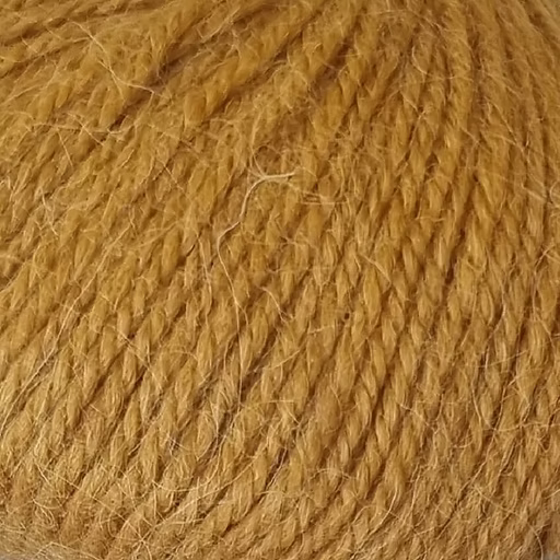 Close-up of ochre-gold yarn with alpaca and merino