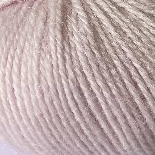 Close-up of light pink yarn with alpaca and merino