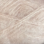 Close-up of pale pink-beige colored yarn with a fluffy mohair texture