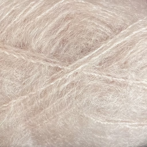 Close-up of pale pink-beige colored yarn with a fluffy mohair texture