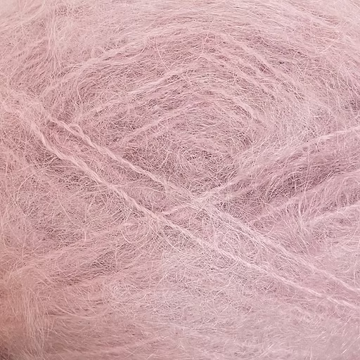 Close-up of pastel pink colored yarn with a fluffy mohair texture