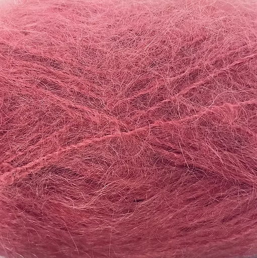Close-up of medium rose pink colored yarn with a fluffy mohair texture
