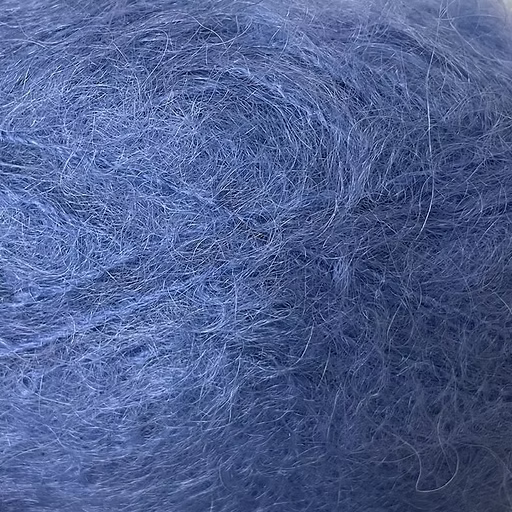 Close-up of deep lapis blue colored yarn with a fluffy mohair texture