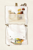 White craft organizer bag with various craft items 