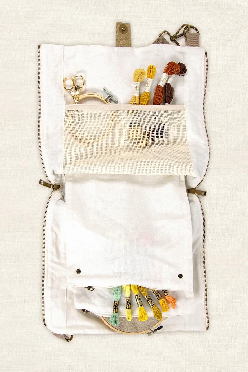 White craft organizer bag with various craft items 