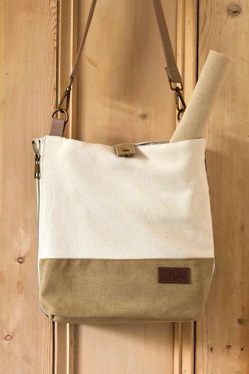 Canvas tote bag with leather accents against a wooden door