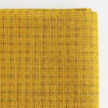 Close-up of a mustard yellow Sashiko fabric with a per=printed grid pattern on a white background