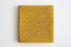 Yellow pre- printed Sashiko fabric on a white background