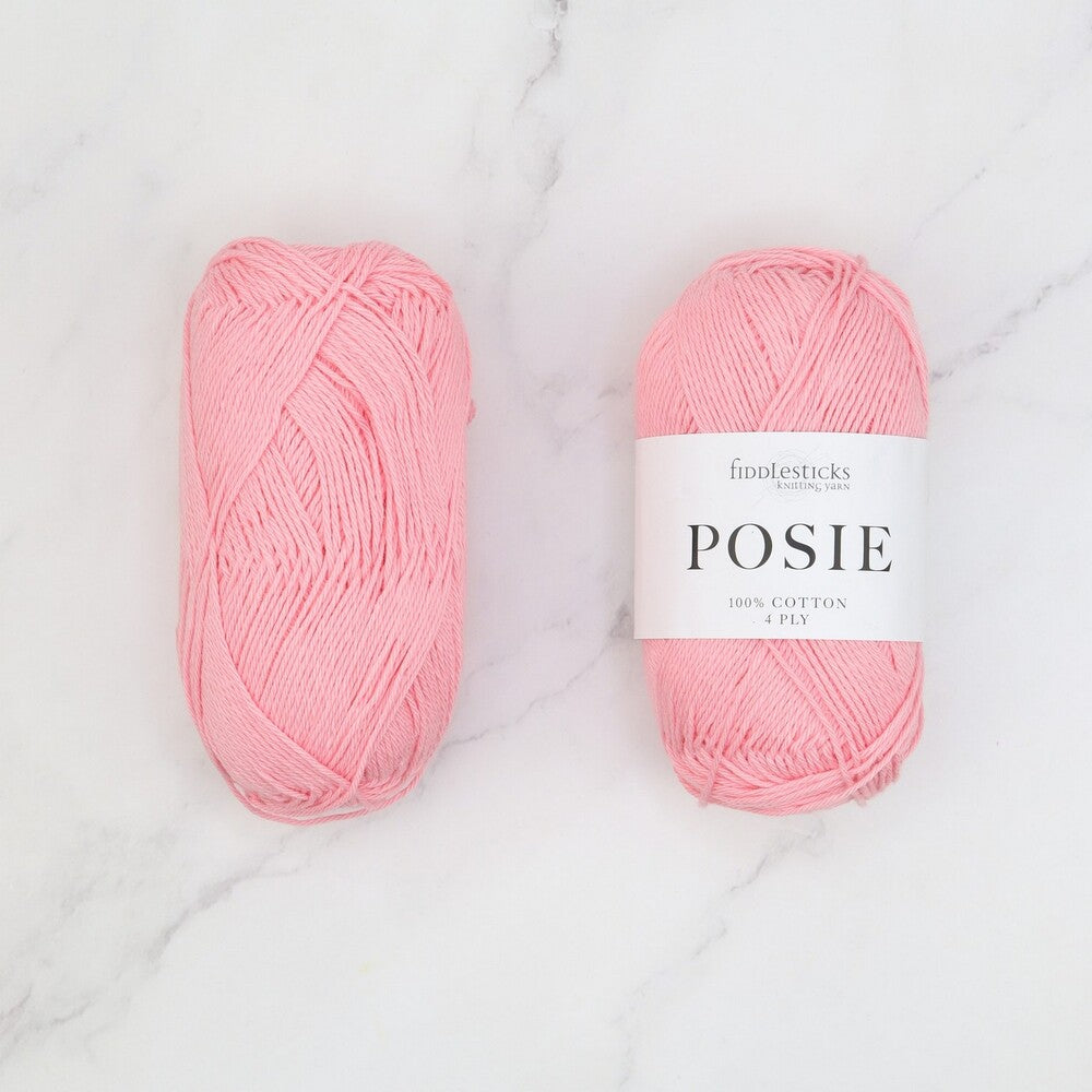 Two balls of Fiddlesticks Posie yarn in a bright pink colour