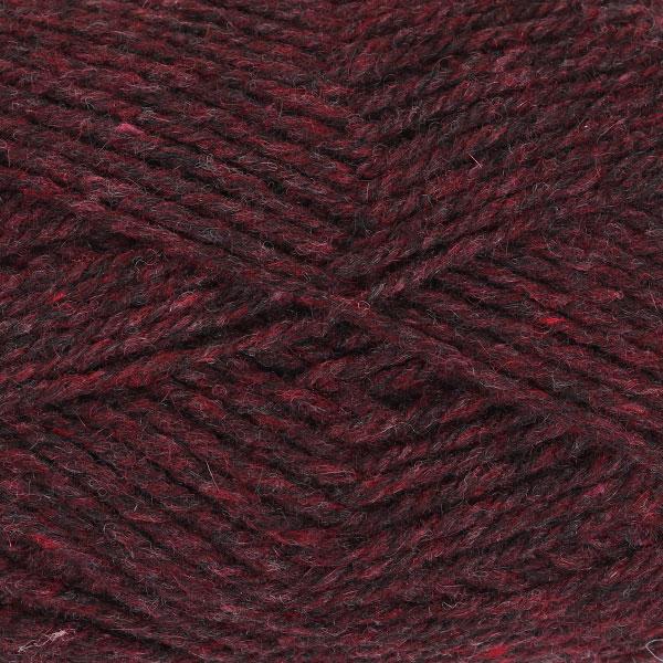 Close-up of dark red yarn with a tweedy texture