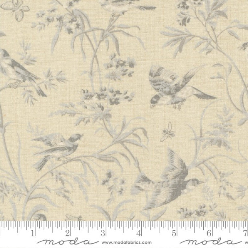 A Quilt fabric featuring a floral and bird design in blue tones on a light blue background, with a ruler at the bottom for scale.