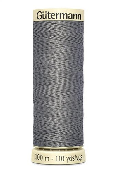 Spool of grey thread with 'Gutermann' branding on a white background