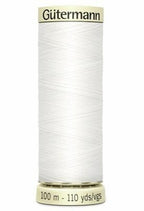 Spool of white thread with 'Gutermann' branding on a white background