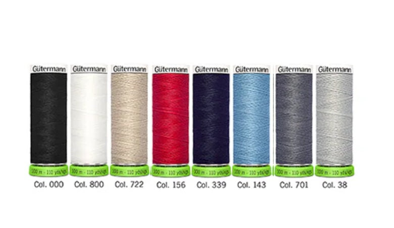 Set of Gutermann thread spools in various colors on a white background
