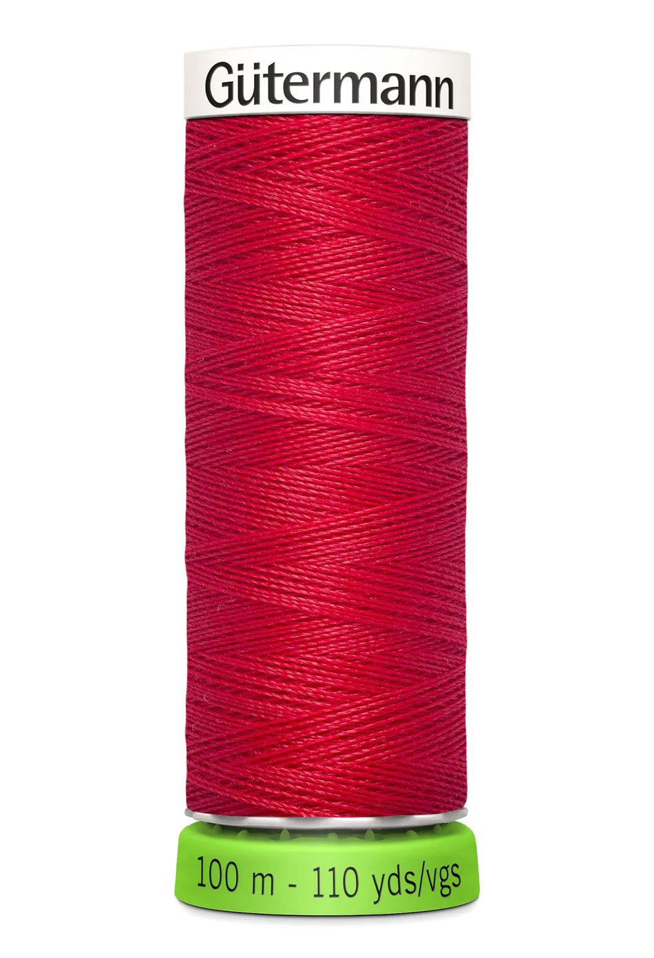 Red spool of Güterman thread on a white background