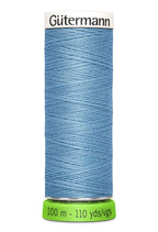 Spool of blue thread with 'Gütermann' branding on a white background