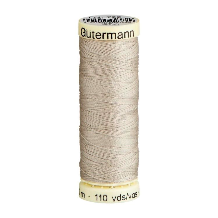 Spool of beige thread with 'Gutermann' branding on a white background