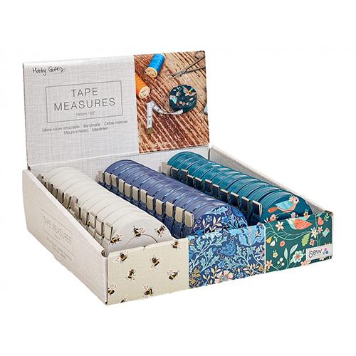 Display of tape measures in a box with various designs.