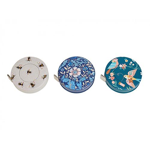 Three decorative tape measures with floral and nature-themed designs on a white background
