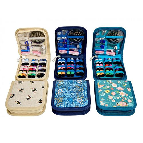 Set of three sewing kits with colorful thread spools and various sewing tools on a white background.