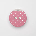 Pink polka dot row counter for knitting or crochet a light gray background