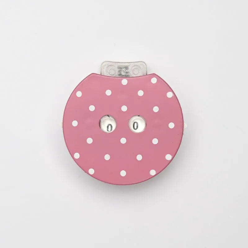 Pink polka dot row counter for knitting or crochet a light gray background
