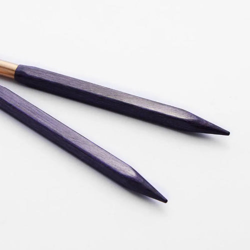Two purple knitting needles on a white background
