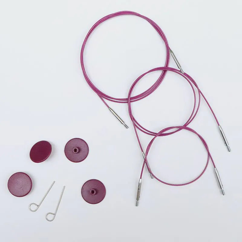 Knitting needles with purple cord and components on a white background