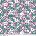 A Liberty of London floral Quilt fabric featuring a repeating design of flowers in pinks and white on a green background.