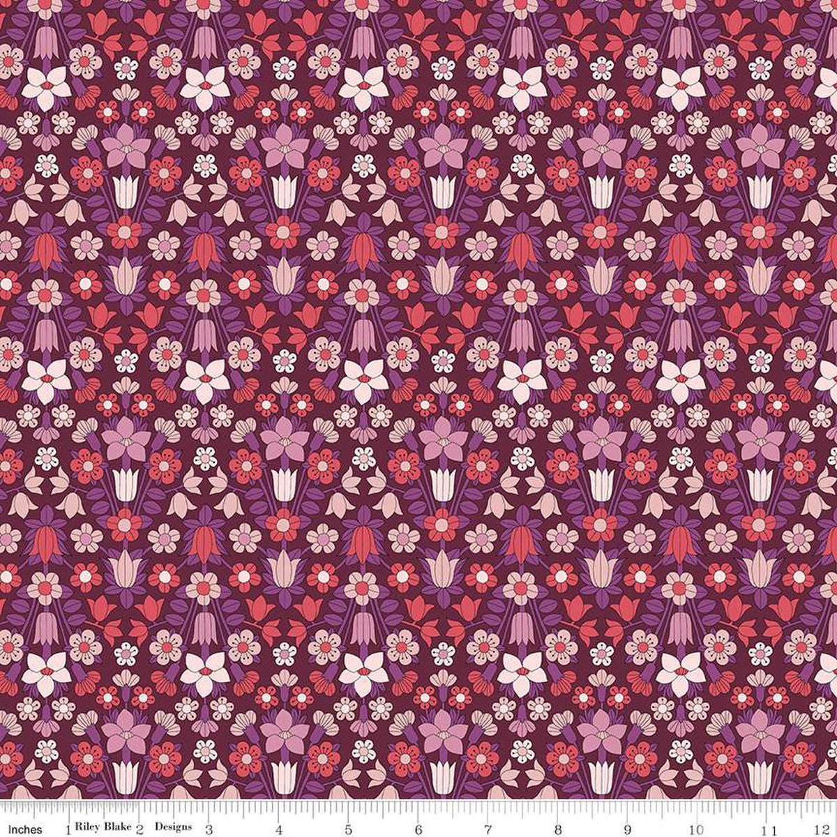 A floral Quilt fabric from the Liberty of London Flower Show Botanical Jewel Collection, featuring a variety of flowers in shades of pink, purple, red, and green on a cotton base.