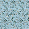 A Quilt fabric featuring garden icons such as watering cans, flowers, and butterflies on a light blue background.