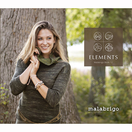 A woman standing outdoors wearing a green knitted cowl neck scarf, with the Malabrigo brand and 'Elements' knitting pattern book cover visible.