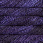 Close-up of multicolored Malabrigo Rios yarn with purple hues.