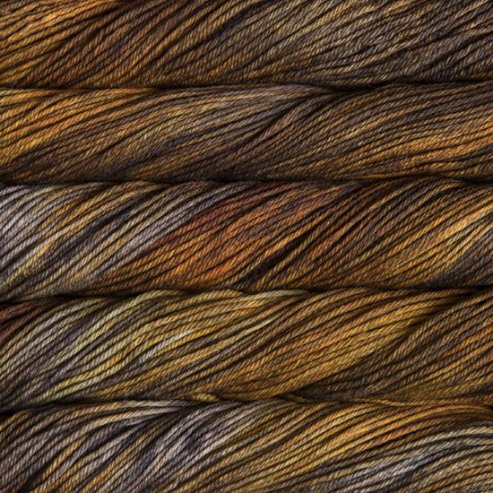 Close-up of multicolored Malabrigo Rios yarn with gold to brown hues.