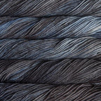 Close-up of multicolored Malabrigo Rios yarn with blue and charcoal hues.  
