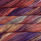 Close-up of multicolored Malabrigo Rios yarn with purple, orange and  amber hues.