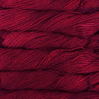 Close-up of multicolored Malabrigo Rios yarn with shades of red to burgundy