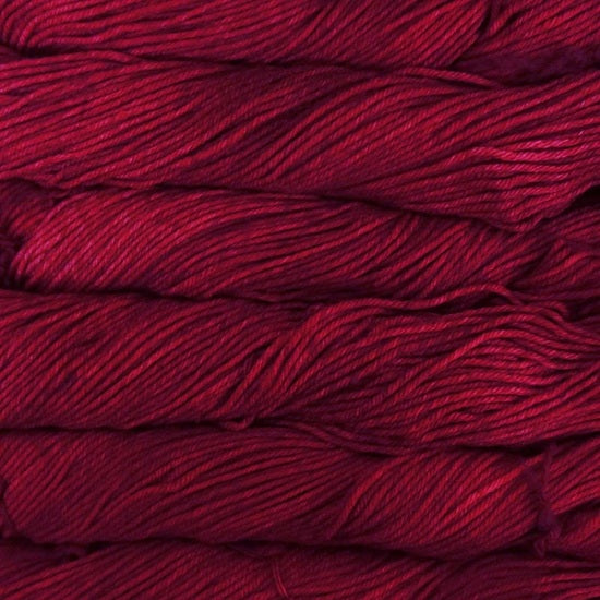 Close-up of multicolored Malabrigo Rios yarn with shades of red to burgundy